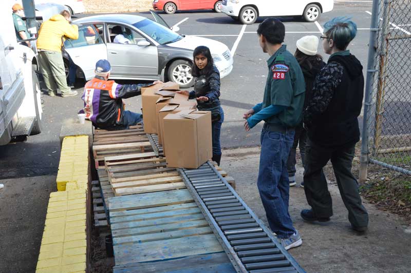 Completed Goodfellows Food Boxes wait to be put into recipients’ vehicles.