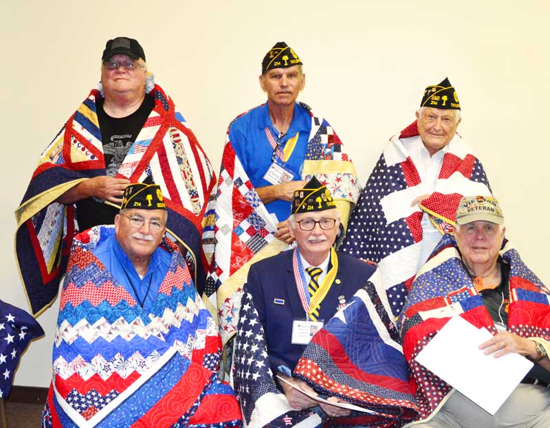 Six members of the American Legion Major Rudolf Anderson, Jr Post 214 were presented with a Quilt of Valor.  Front Row: Alan James, Clyde Rector and Lowery Smith; Back Row: Ed Collins, Chris Baird and Charlie Clifton.