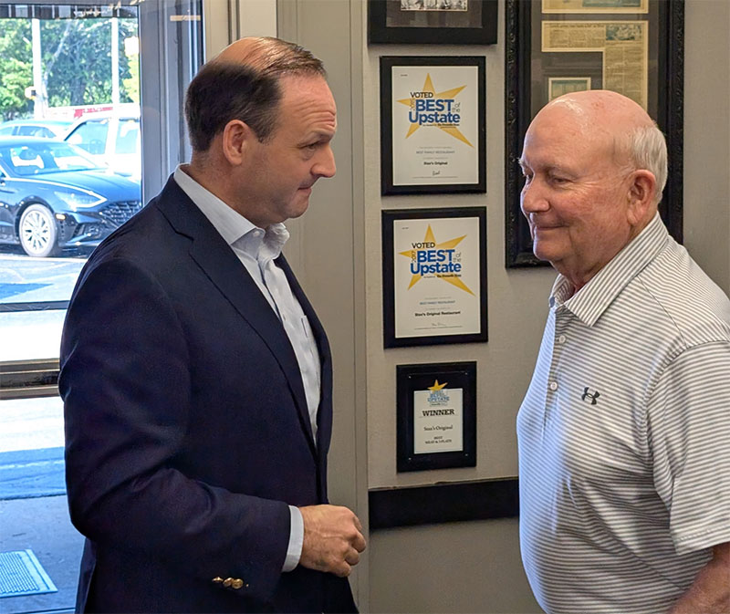 Alan Wilson speaks with a voter during a recent campaign stop in Greenville 2