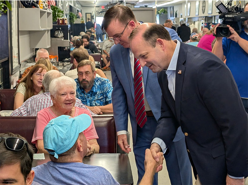 Alan Wilson speaks with a voter during a recent campaign stop in Greenville