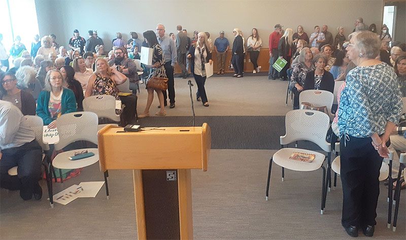 a standing room only crowd at library board