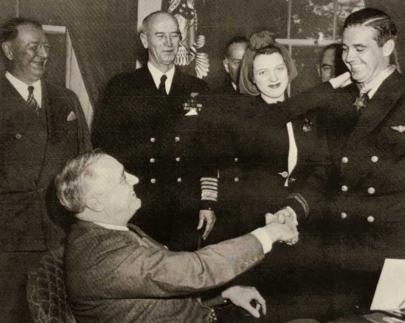 President Franklin Roosevelt awards the Congressional Medal of Honor, April 21, 1942, to Lt. Lohmander Boward O'Hare, Jr. Ruth O'Hare is beside her husband. - Photo credit: National Archives/Public Domain