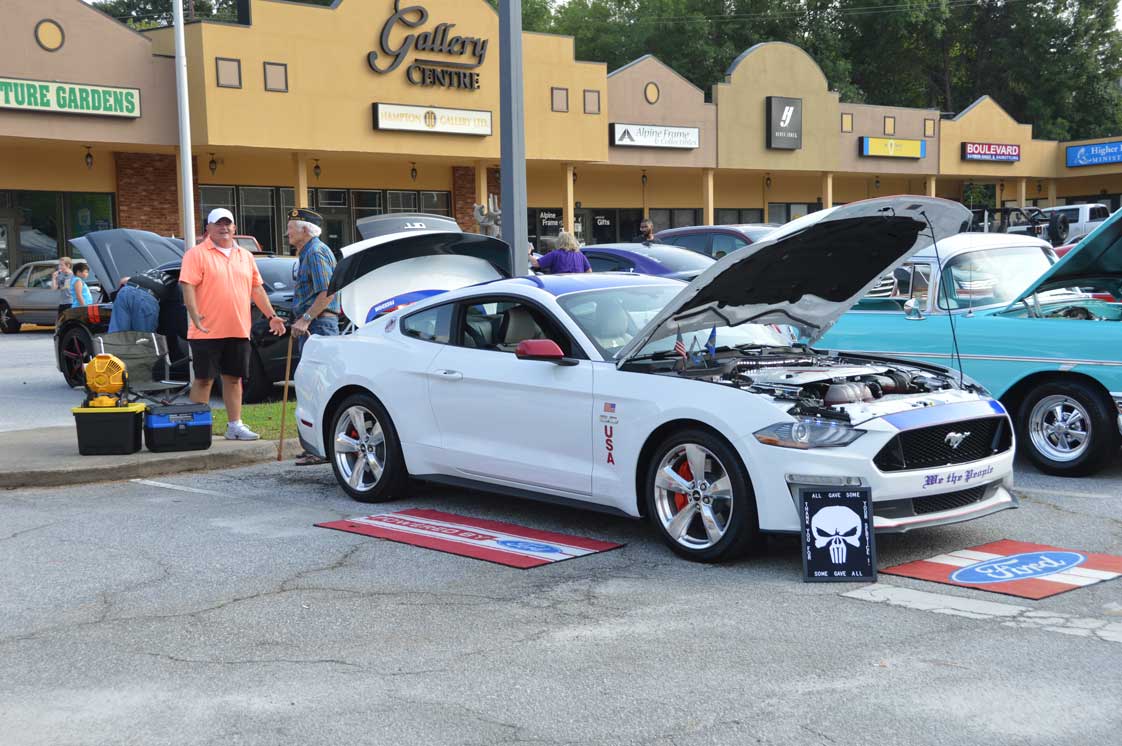 Post 214 member Roy Brock welcomes Timothy Scharf to Post 214 care show.