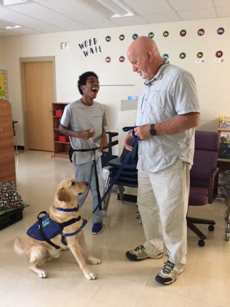 Once a month, Mr. Skeeter Powell brings his companion dog, Chief, to visit with students at Washington Center.  The students learn pet care skills and enjoy interacting with their patient canine friend.