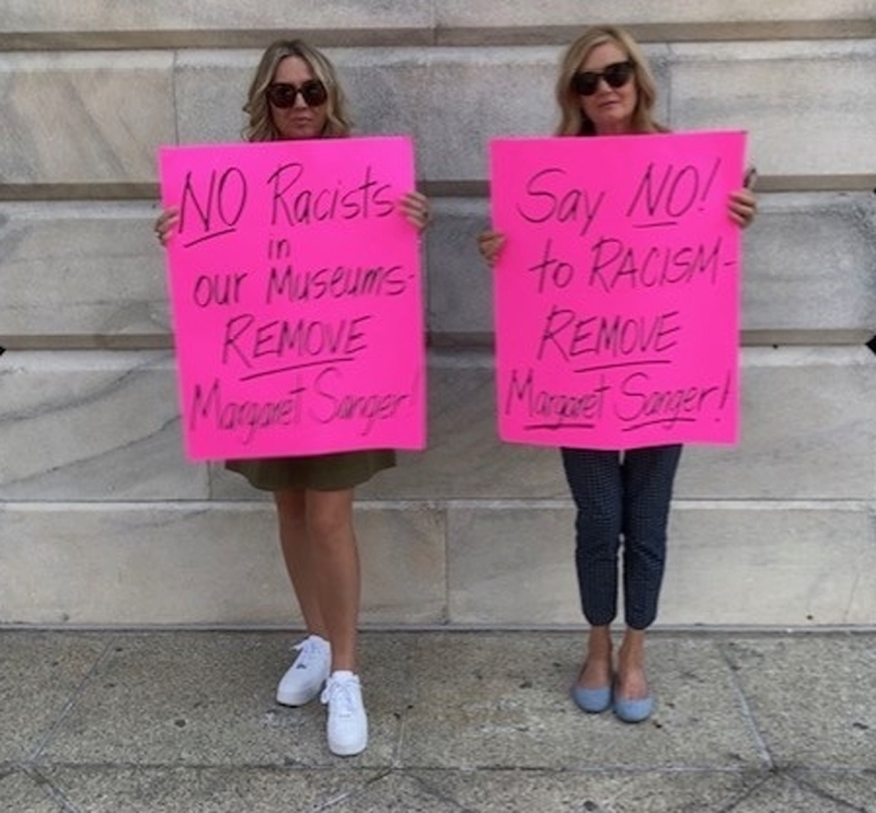 Brandi Swindell and Katie Mahoney calling for the removal of the Margaret Sanger display.