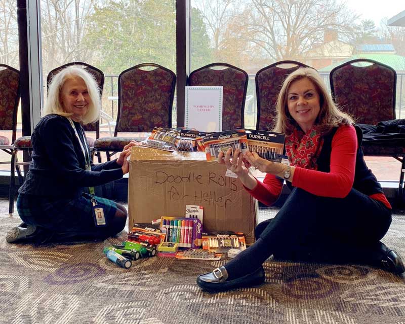 Washington Center staff members, Linda Thigpen (left) and Julie Dail (right) accept gifts for the school thanks to the generosity of Furman University’s Heller Service Corps.