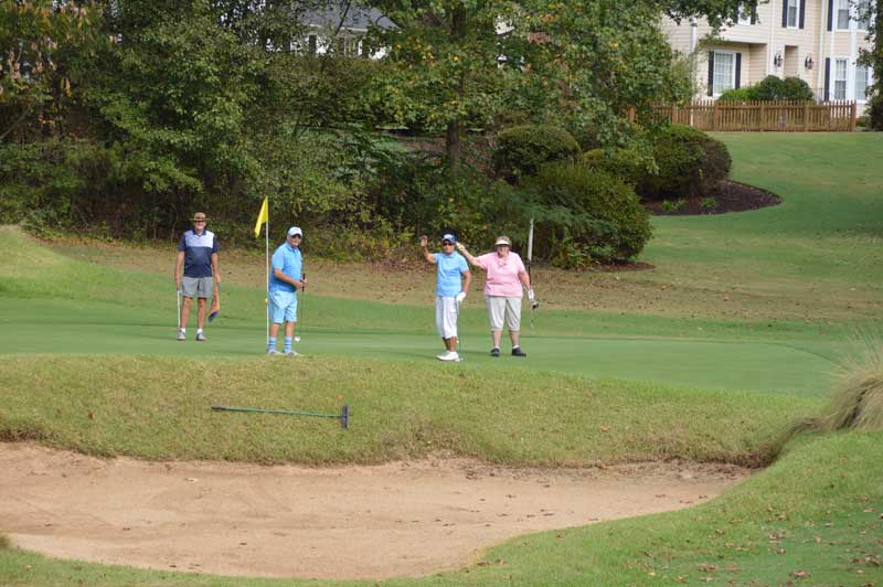 Golfers enjoying the greens.