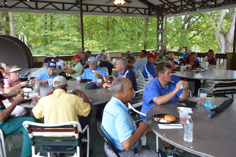 After the tournament, golfers enjoy a meal.