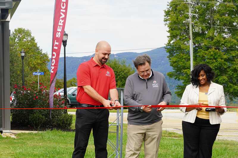 IT Center Dedication_print: North Greenville University President Dr. Gene C. Fant, Jr. (center) and members of the NGU Board of Trustees cut the ceremonial ribbon to signify the opening of the new IT Center at a dedication ceremony on Friday, October 16.