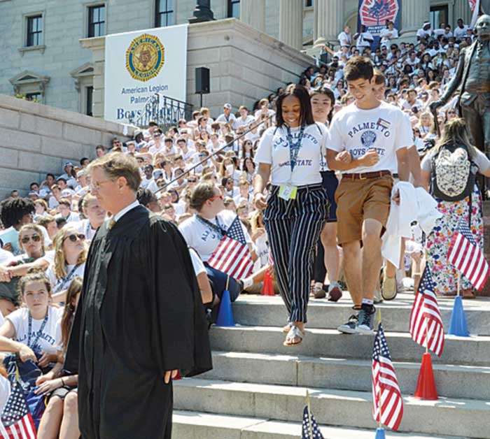 Associate Justice George James, Jr. of SC Supreme Court leads the Palmetto Boys and Girls State Chief Justices down the steps of the State Capitol.