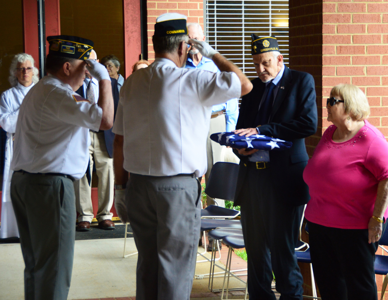 American Legion Post 120 Honor Guard members render a hand-salute at the US Flag that was presented to American Legion Post 3 member Gilbert Scales as his wife Harriette looks on. The US Flag was in honor of US Air Force veteran Frederick Scales who passed on August 2nd, 2018.