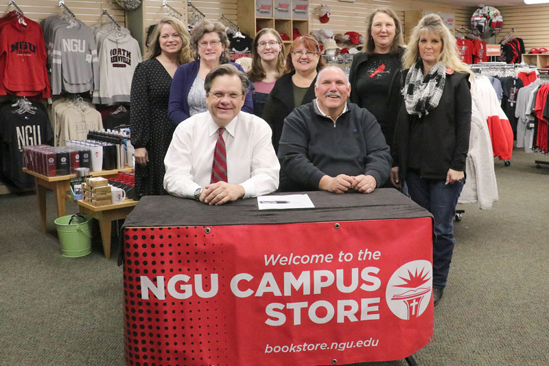 Sitting from left: NGU President Dr. Gene C. Fant, Jr., and Associate Vice President for Tigerville Operations Billy Watson. Standing from left: Senior Vice President for Finance Michelle Sabou with members of the NGU Campus Store staff.”