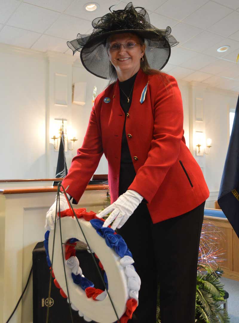 Pam Durham of American Legion Major Rudolf Anderson, Jr. Post 214 perform s a wreath-laying ceremony for POW/MIA at Wrenn Memorial Baptist Church.