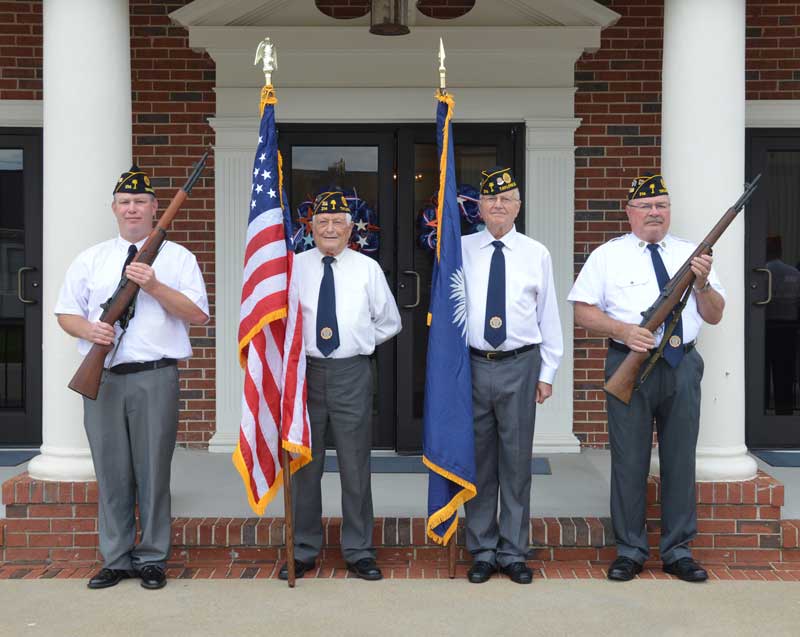 Dale McCoy, Charles Clifton, Jim Nichols, Bruce Bartlett, Color Guard members of Major Rudolf Anderson, Jr. Post 214 outside Wrenn Memorial Baptist Church preparing for Posting the Colors.
