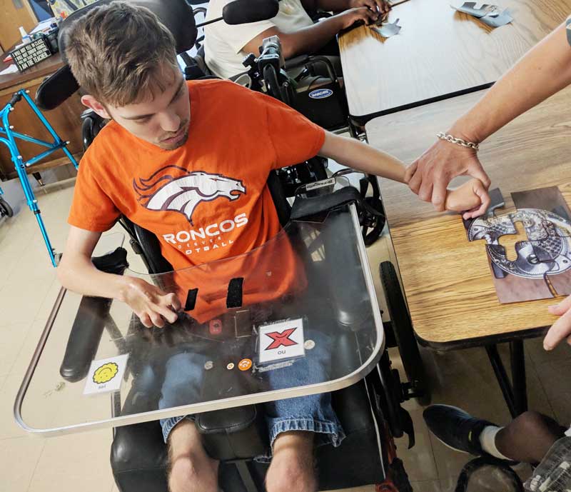 Washington Center student Sam Frederick is pictured solving puzzles during a Labor Day Escape Room activity.